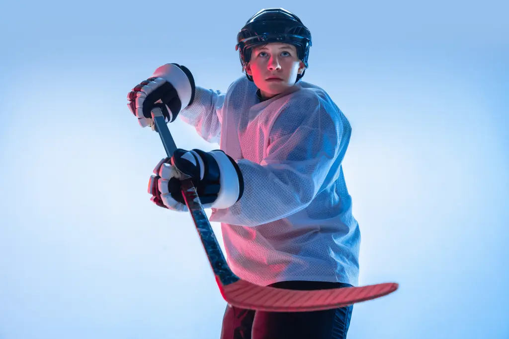 youth-young-male-hockey-player-with-the-stick-on-white-background-in-neon-light-sportsman-wearing-equipment-and-helmet-practicing-concept-of-sport-healthy-lifestyle-motion-movement-action.jpg